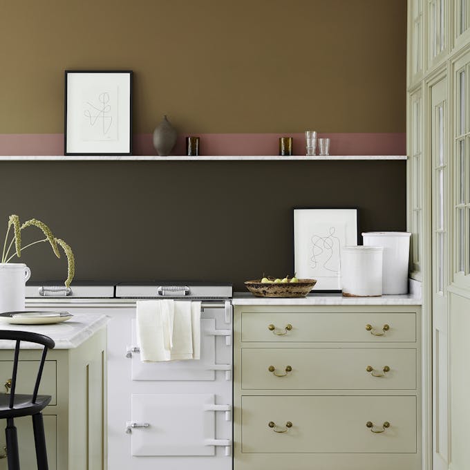 Kitchen scheme with neutral cabinets, dark brown (Elysian Ground) and warm brown (Light Bronze Green) walls with pink stripe.