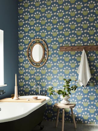 Bathroom with snail-printed wallpaper (Burges Snail - Juniper) on back wall and deep blue (Juniper Ash) on left wall.