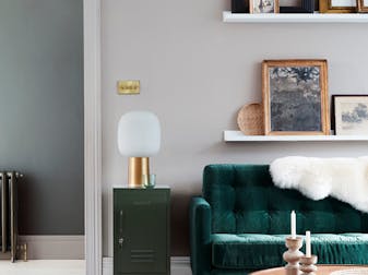 Velvet forest green sofa in front of a light grey (French Grey) wall and on top of bright white wood flooring in Loft White.