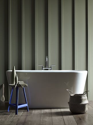 Bathroom featuring 'Sage Green' paneled walls, a white freestanding bathtub and a Purple-Blue stool in 'Mambo'.