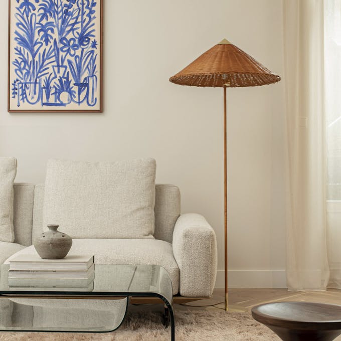 A neutral living room scheme with beige sofa and off-white (Portland Stone) painted wall featuring a blue and white painting.