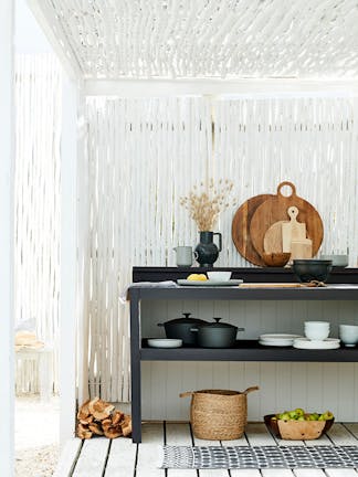 Outdoor kitchen area made from bamboo painted in bright white 'Loft White' with a contrasting black kitchen unit.