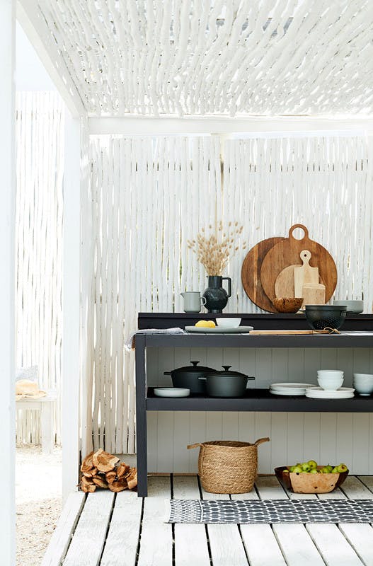 Outdoor kitchen area made from bamboo painted in bright white 'Loft White' with a contrasting black kitchen unit.