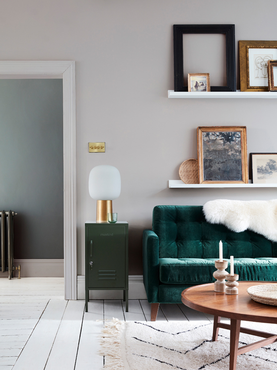 Velvet forest green sofa in front of a light grey wall (French Grey) and on top of bright white wood flooring in Loft White.