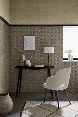 Indoor study with two shades of small scale wallpaper 'Moy' (Lime and Pompei) with a black desk and white chair.