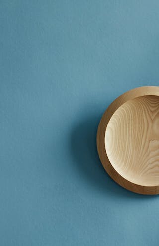 Close-up of a blue wall with plates hanging on a wall.