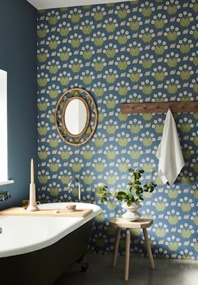 Bathroom with snail-printed wallpaper (Burges Snail - Juniper) on back wall and deep blue (Juniper Ash) on left wall.