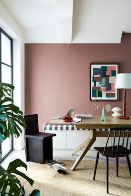 Dining space with a dining room table and black chairs, a red back wall (Nether Red) and clean white left wall and ceiling.