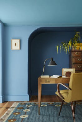 Home office space with an alcove painted in three shades of blue ('Woad', 'Tivoli' and 'Blue Verditer') with a wooden desk and chair.