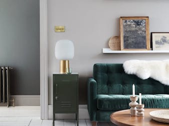 Velvet forest green sofa in front of a light grey (French Grey) wall and on top of bright white wood flooring in Loft White.