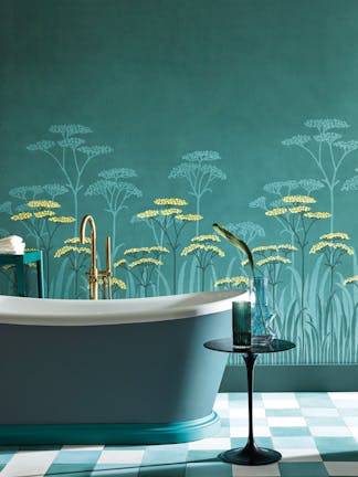 Bathroom with dark green (Harley Green) bath in front green floral mural wallpaper and yellow accents (Achillea - Aurora).