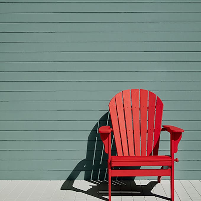 Exterior panelled wall in green blue shade (Pleat) with a bright Atomic Red chair and neutral Cool Arbour panelled floor.