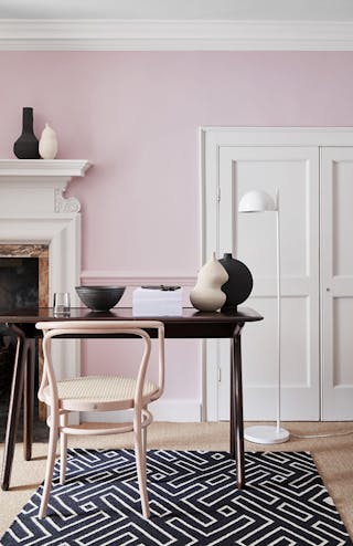 Home office with pale pink (Pink Slip) walls and constrasting neutral woodwork alongside a fireplace, wooden desk and chair.