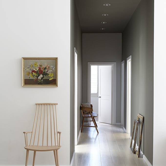 Hallway with off white (Wood Ash) facing wall and darker grey Cool Arbour and Grey Moss walls in a narrow corridor.