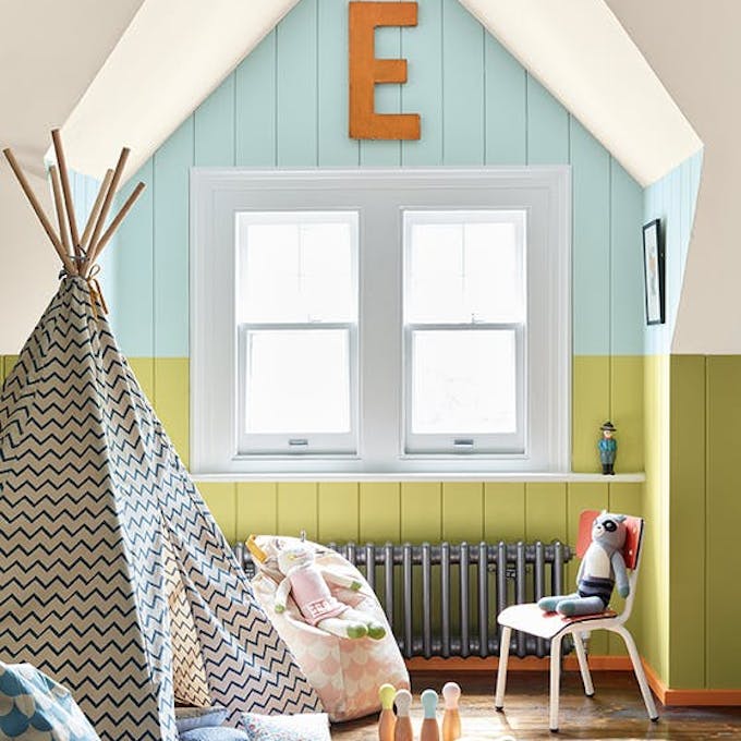 Nursery featuring a Pale Lime green and pale blue-green (Brighton) paneled wall, and bright orange baseboards (Marigold).