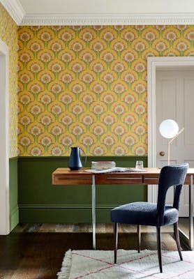 Home study space with the lower wall painted in deep green and yellow floral wallpaper (Hencroft - Punch) on the upper wall.