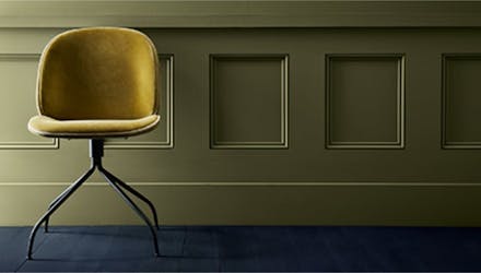 Mustard yellow velvet chair against a dark green panelled wall in Olive Colour and a dark indigo blue floor in Dock Blue.