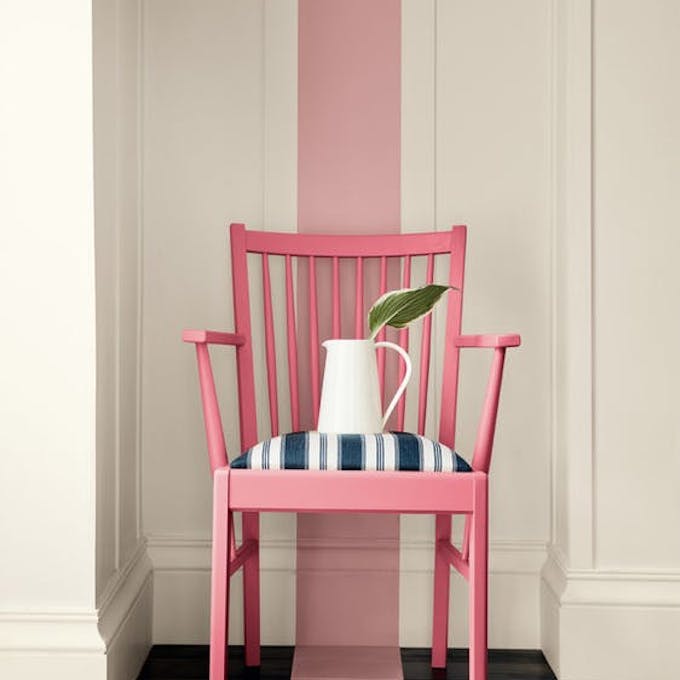 Dark pink (Carmine) chair with a dusky pink stripe painted from the wall down to the navy blue panelled floor.