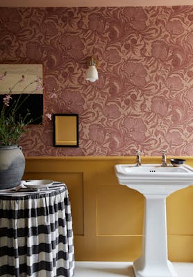 Bathroom with pink floral wallpaper (Poppy Trail - Masquerade) on the upper wall and yellow on the bottom half (Yellow-Pink).