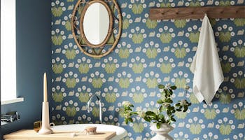 Bathroom with snail-printed wallpaper (Burges Snail - Juniper) on back wall and deep blue (Juniper Ash) on right wall.