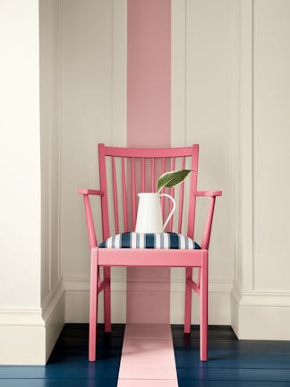 Dark pink (Carmine) chair with a dusky pink stripe painted from the wall down to the navy blue panelled floor.