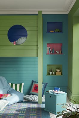 Panelled children's bedroom painted in turquoise 'Canton' and deep green 'Garden' with three shelves and a bunk bed.