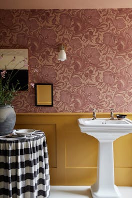 Bathroom with pink floral wallpaper (Poppy Trail - Masquerade) on the upper wall and yellow on the bottom half (Yellow-Pink).