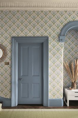 Hallway with blue and pink floral wallpaper (Hencroft - Blue Primula) and matching door and woodwork painted in blue grey.