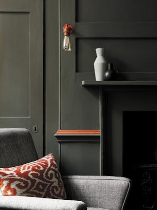 Living room color drenched in grey/ green shade 'Pompeian Ash' with a deep red contrast stripe and a grey sofa.