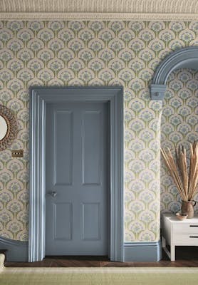 Hallway with blue and pink floral wallpaper (Hencroft - Blue Primula) and matching door and woodwork painted in blue grey.