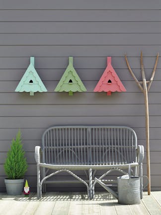 Three birdhouses painted in light blue, green and pink on a luxury grey wall painted in Dark Lead Colour.