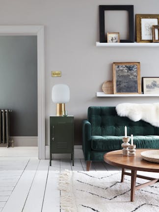 Velvet forest green sofa in front of a light grey (French Grey) wall and on top of bright white wood flooring in Loft White.