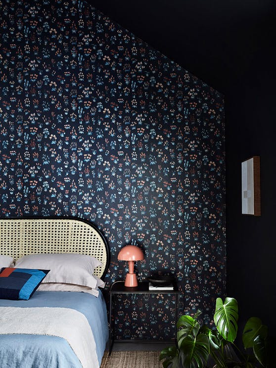 Bedroom with blue small floral wallpaper 'Millefleur - Knight' and deep blue 'Basalt' walls.