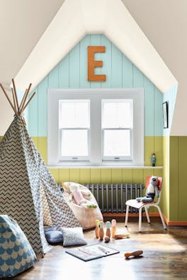 Children's playroom with a teepee, skittles and toys with a pale blue (Brighton) and bright green (Pale Lime) panelled wall.