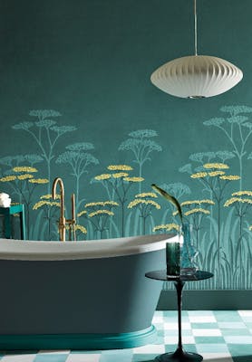 Bathroom with dark green (Harley Green) bath in front green floral mural wallpaper and yellow accents (Achillea - Aurora).