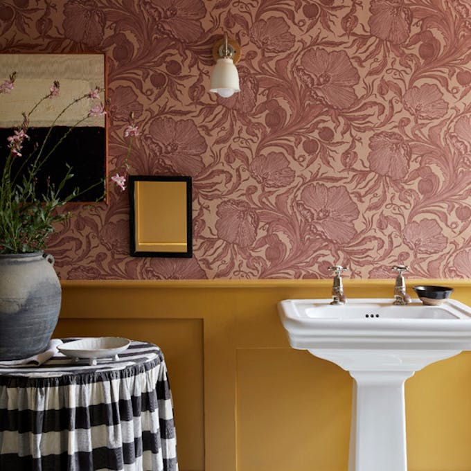 Bathroom with pink floral wallpaper (Poppy Trail - Masquerade) on the upper wall and yellow on the bottom half (Yellow-Pink).